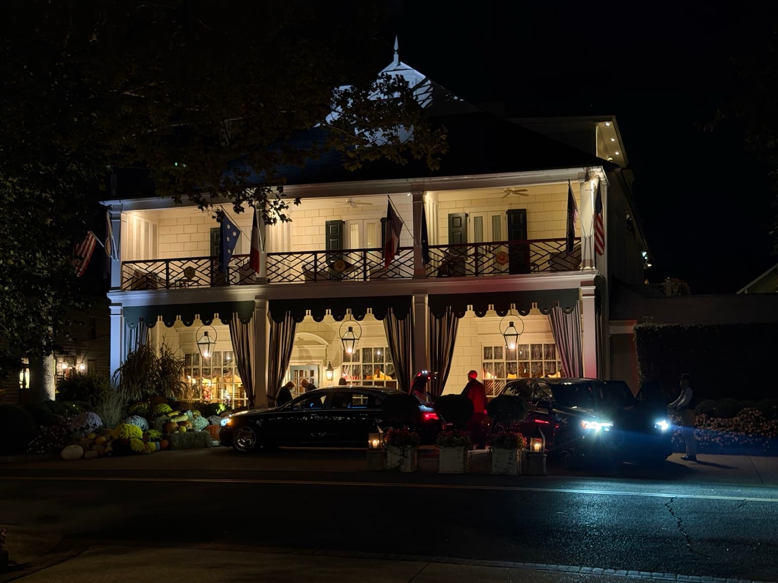 The Inn at Little Washington illuminated at night, with black cars outside