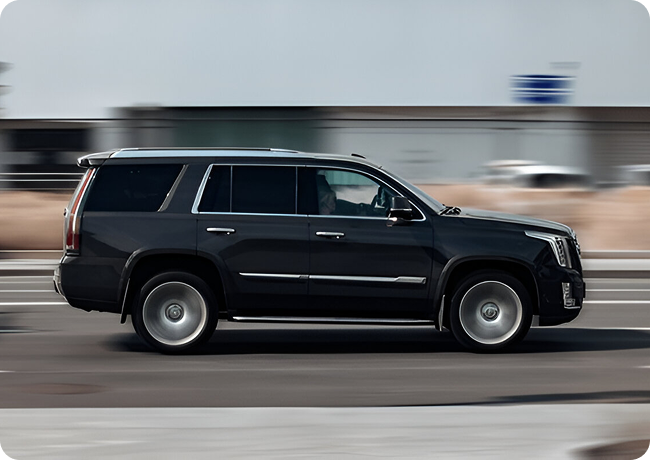 Genius Limo chauffeur beside a luxury black car available for private hire